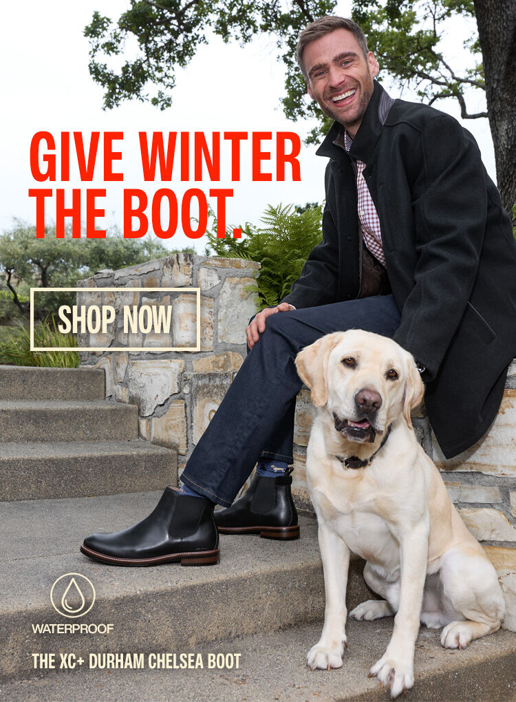 Man and dog sitting on stone steps outside.